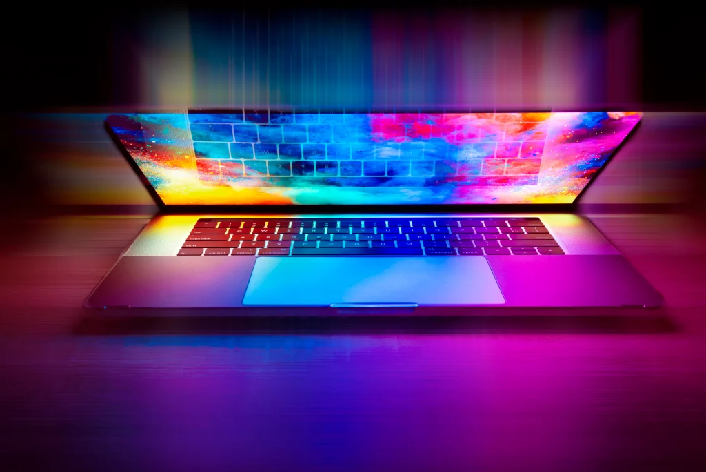 Laptop with colourful abstract lights almost closed top.